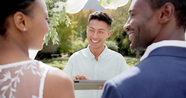 Smiling Officiant Conducting Outdoor Wedding Ceremony for Happy Couple - Download Free Stock Images Pikwizard.com