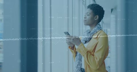 Mixed-Race Businessman Analyzing Financial Data on Smartphone