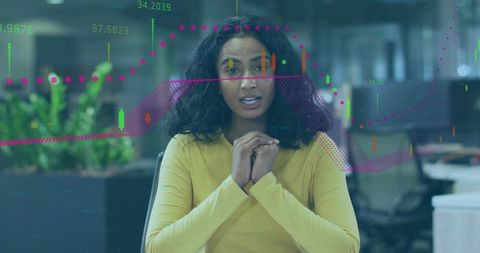 Female Presenter Discussing Stock Market Data with Candlestick Charts in Modern Workspace