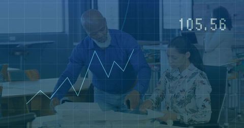 African descent colleague reviewing presentation with teammate in architect studio