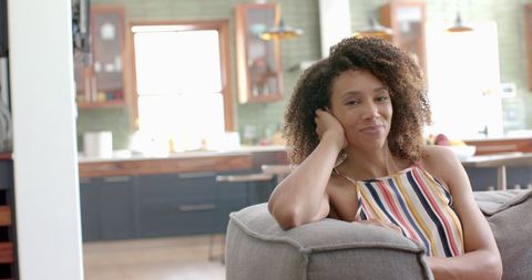 Biracial Woman Relaxing on Sofa in Cozy Home Environment