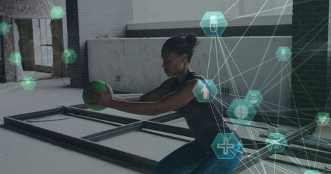 Woman Exercising with Ball Enhanced by Digital Health Interface