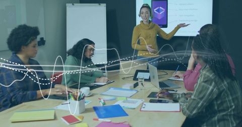 Diverse Team Collaborating During Office Meeting with Presentation