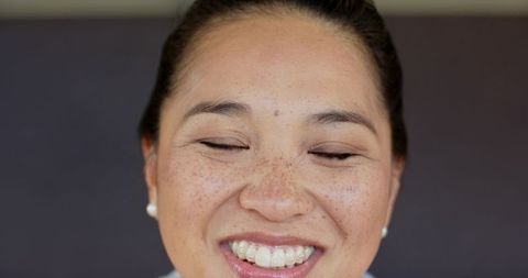 Mid adult woman smiling serene expression eyes closed