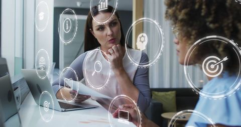 Two Diverse Women Collaborating with Digital Business Technology