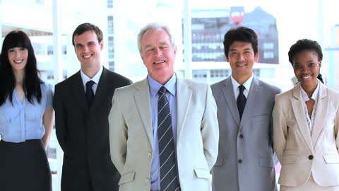 Diverse Business Team Smiling in Bright Workspace