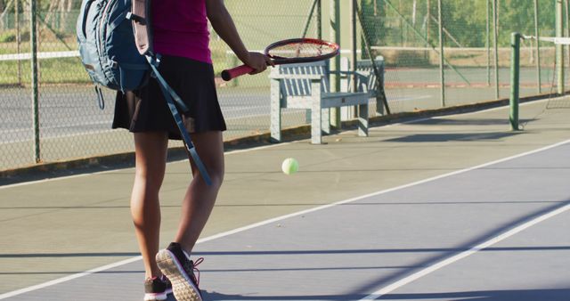 Female tennis player walking with racket on outdoor court - Download Free Stock Images Pikwizard.com