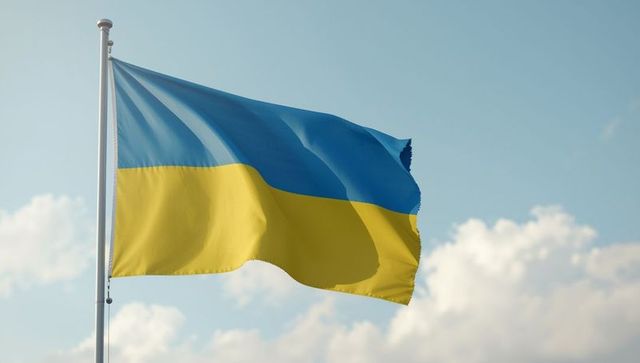 Fluttering ukrainian flag against blue sky