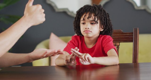 Young African American Child Learning Sign Language at Table - Download Free Stock Images Pikwizard.com