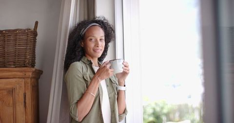 Relaxed Woman with Coffee by Bright Living Room