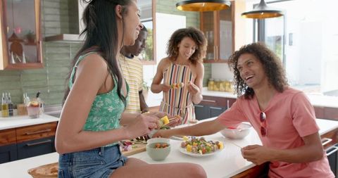 Diverse Friends Enjoying Meal in Modern Kitchen Setting