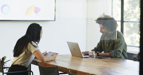 Diverse Business Colleagues Collaborating with Technology in Modern Office