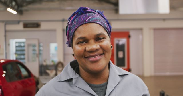 Female Mechanic Smiling Inside Auto Repair Shop - Download Free Stock Images Pikwizard.com