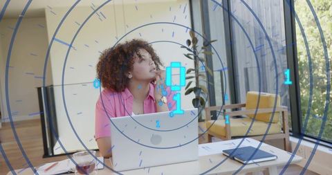 Remote worker planning with futuristic HUD overlay in bright modern home office workspace