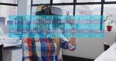 Woman wearing vr headset manipulating holographic data grid in modern office workspace