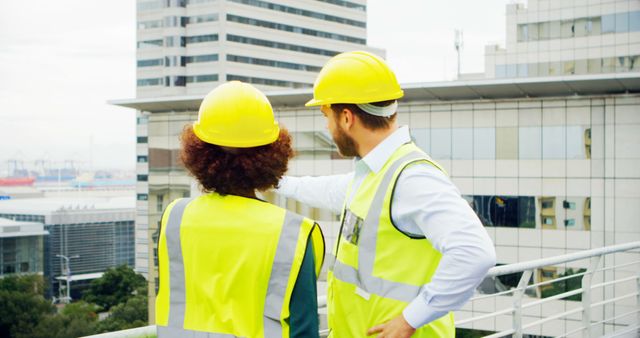 Construction Workers Overseeing Urban Project on Rooftop - Download Free Stock Images Pikwizard.com