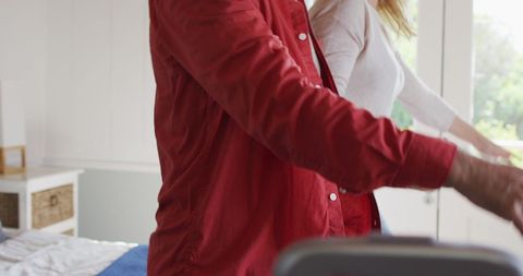 Elderly couple in red and white relaxing in hotel