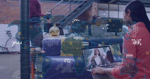 Woman in red blazer typing and engaging remote colleague on laptop with world map overlay