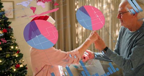 Senior couple sharing festive forearm touch with data overlays and cozy christmas interior