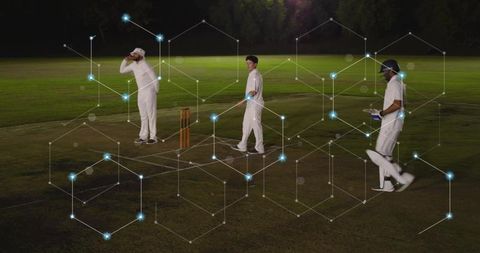 Cricket players adjusting gear on floodlit night pitch with hexagonal network overlay