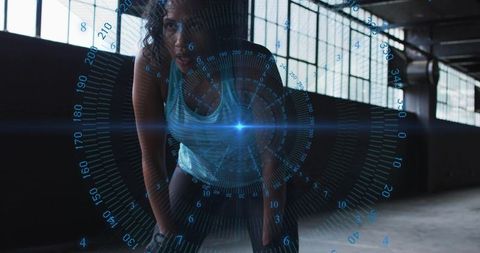 Lean athlete catching breath after HIIT training with blue HUD overlay in industrial gym