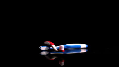 Two Colorful Toothbrushes Falling Dramatically