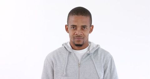 Confident Man in Gray Hoodie Against White Background - Download Free Stock Images Pikwizard.com