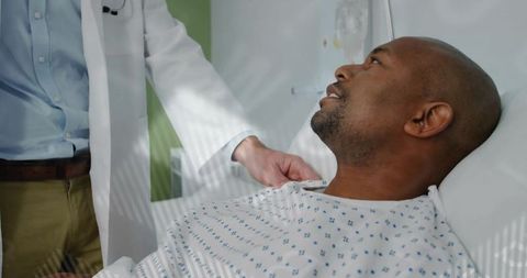Doctor Examining Patient in Hospital Bed with Care