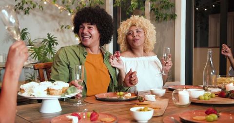 Diverse Friends Toasting at Lively Celebration Dinner