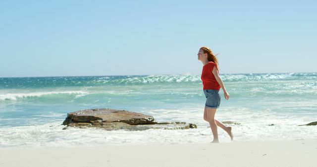 Woman Enjoying a Walk on a Sunny Beach - Download Free Stock Images Pikwizard.com