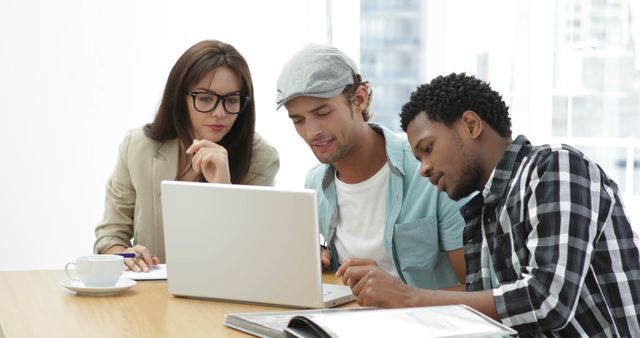 Diverse Team Collaborating on Laptop in Bright Office Meeting - Download Free Stock Images Pikwizard.com