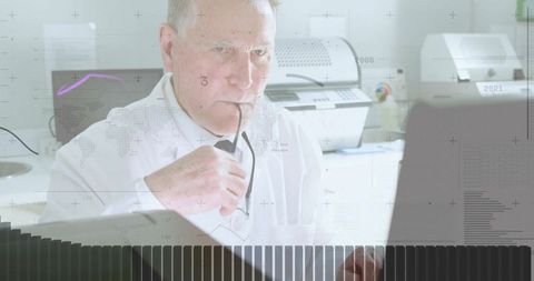 Senior Professional Analyzing Data on Laptop in Modern Office