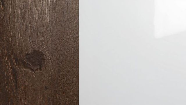 Dark brown wood next to glossy white panel, vertical seam and subtle shine