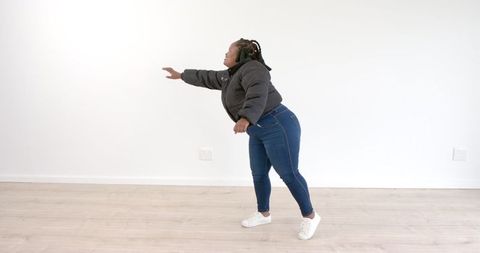 Confident Woman Reaching Forward in Minimalist Space