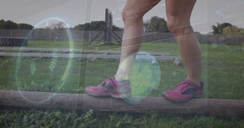 Balancing on low beam in pink runners with hud overlay for outdoor fitness focus