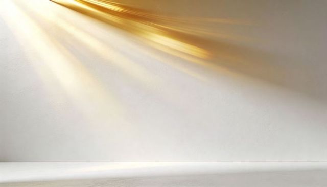 Golden sunlight beams casting warm diagonal light across minimal textured plaster wall