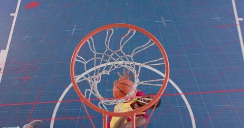 Dynamic Slam Dunk on a Tech-Themed Blue Basketball Court