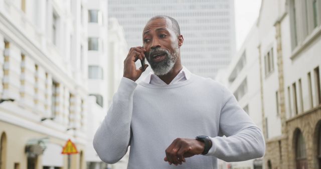 Mature Businessman Talking on Phone and Checking Time on Busy City Street - Download Free Stock Images Pikwizard.com