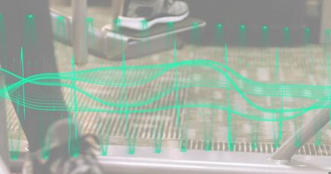 Commuters' feet standing on train floor with sneakers and green data wave overlay