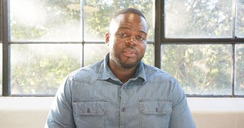 Confident African American Man Speaking in Bright Office