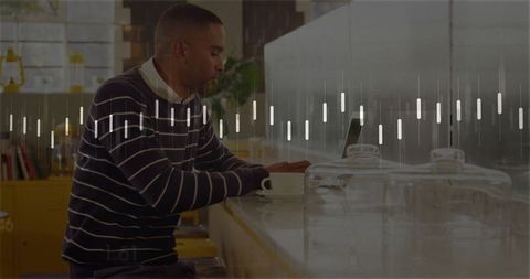 Focused Man Working at Laptop in Modern Coffee Shop Environment
