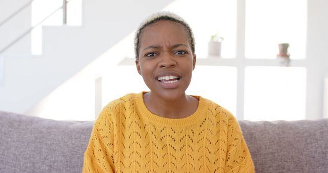 Confused Woman in Bright Yellow Sweater Expressing Concern - Download Free Stock Images Pikwizard.com