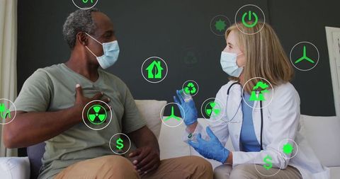 Doctor consulting patient in masks with eco-friendly icons floating