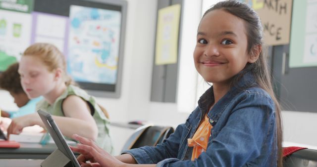 Smiling Girl Using Tablet in Classroom - Download Free Stock Images Pikwizard.com