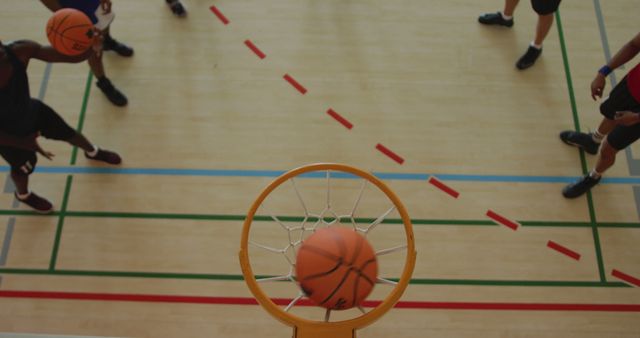 Overhead view of african american male basketball player scoring goal against diverse players - Download Free Stock Photos Pikwizard.com