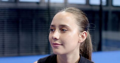 Focused Female Athlete in Sports Hall with Court Flooring