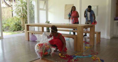 Family collaborating on post-party clean up chores at home