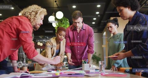 Creative team brainstorming around table with colorful notes and smartphone design sprint