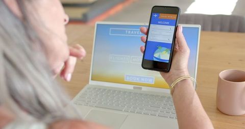 Mature Woman Booking Travel Online at Home with Smartphone - Download Free Stock Images Pikwizard.com