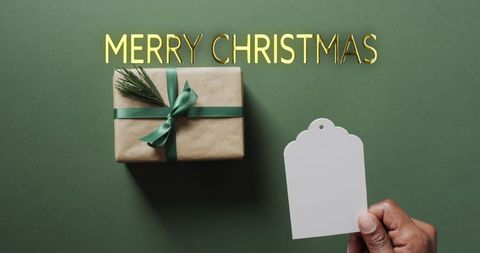Christmas gift box with tag and gold merry christmas text